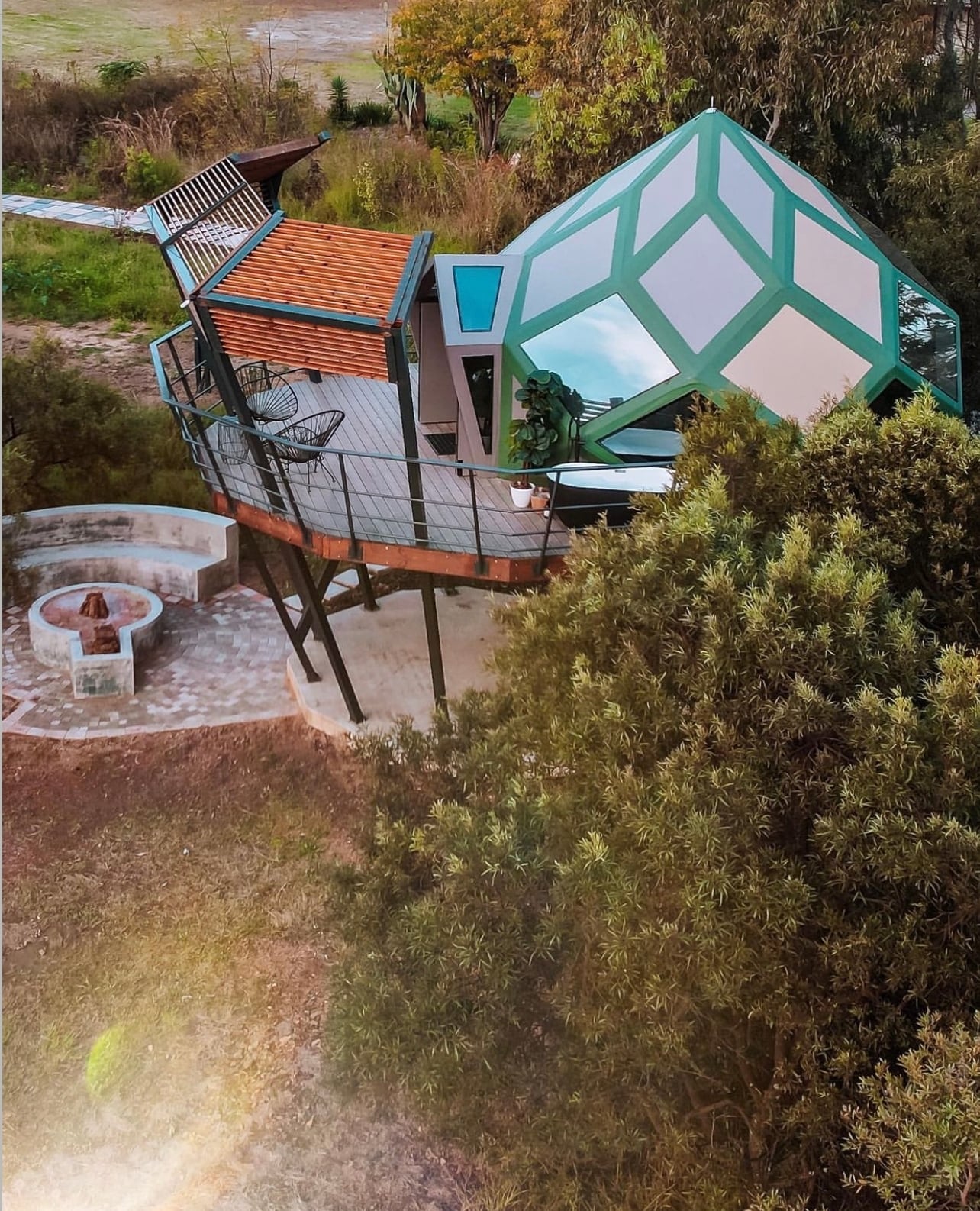 Green-framed dome and its raised deck above the trees at Rosemary Hill, an earlier GeoMod geometry